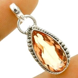 12 carat padparasha pendant.925 sramped 925 sterling silver. Light pinkish hue